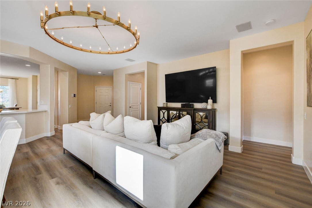 2649 Rue Marquette Avenue Henderson, NV 89044 - Photo 12 of 55 This ample living area boasts a modern chandelier and durable plank flooring.