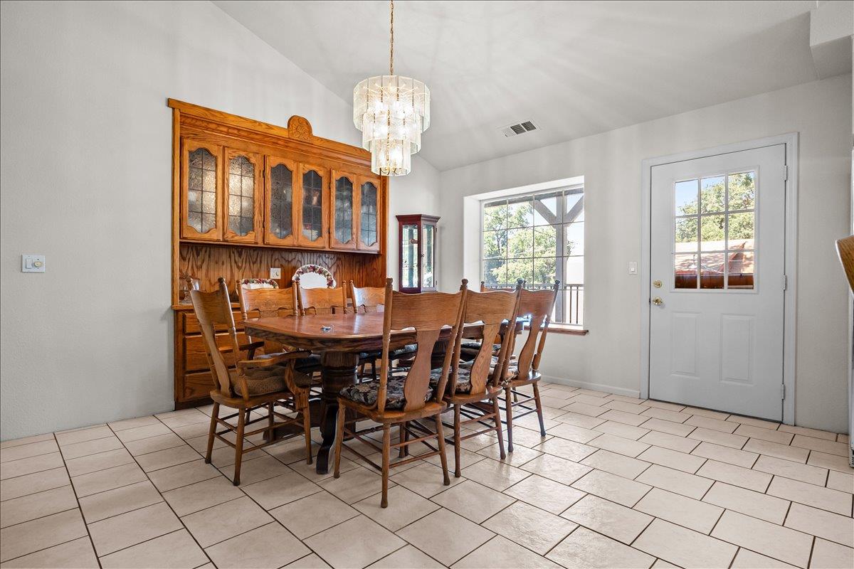 893 Wetherbee Avenue Manteca, CA 95337 - Photo 11 of 39 a view of a dining room with furniture and chandelier