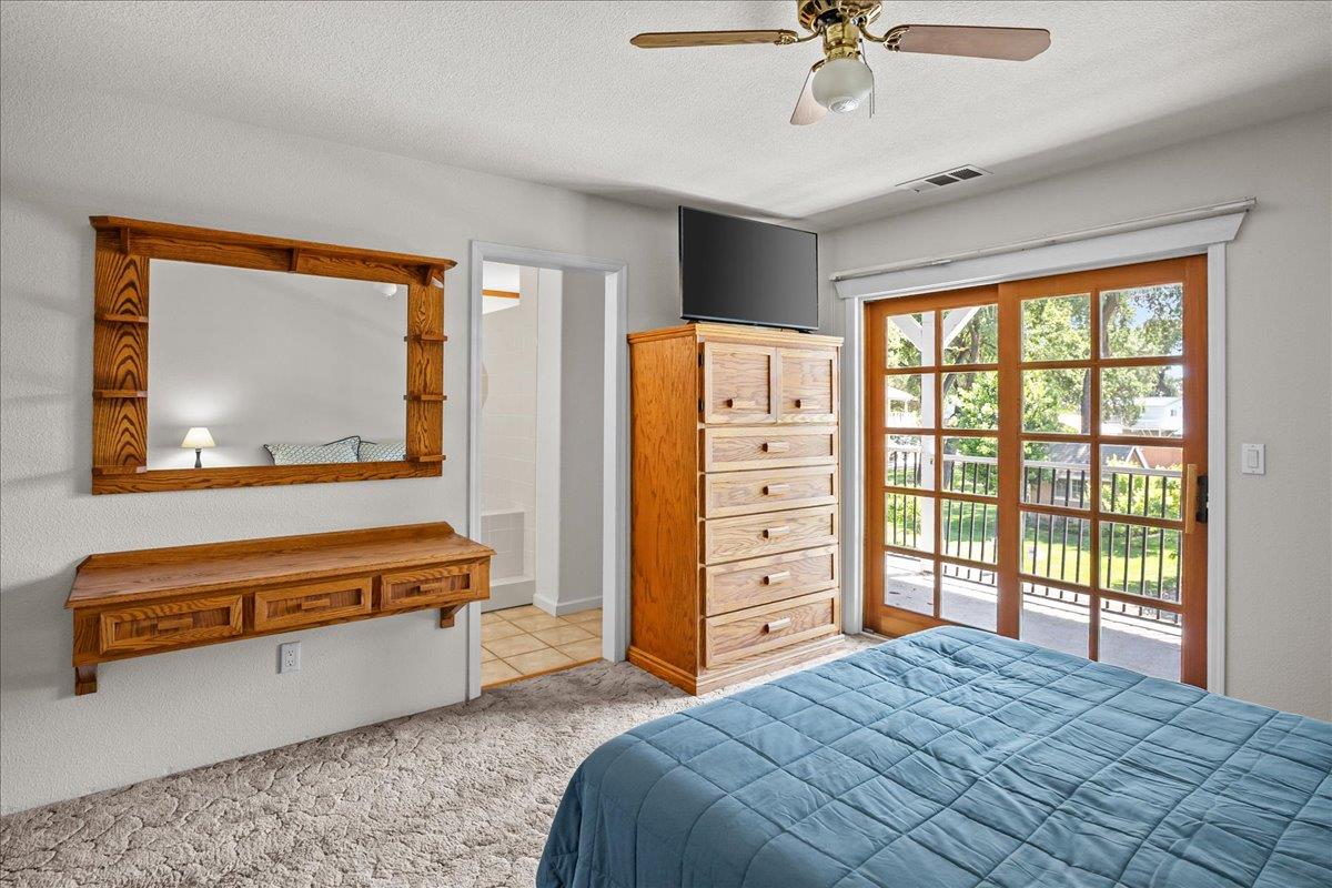 893 Wetherbee Avenue Manteca, CA 95337 - Photo 14 of 39 a bedroom with a bed and a chandelier