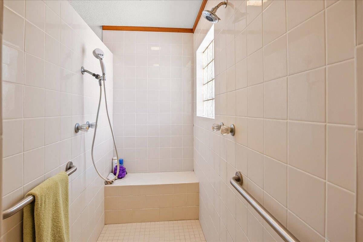 893 Wetherbee Avenue Manteca, CA 95337 - Photo 18 of 39 a bathroom with a bathtub a sink and a shower