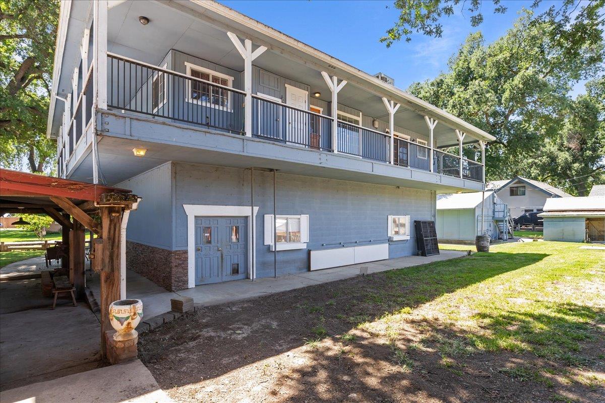893 Wetherbee Avenue Manteca, CA 95337 - Photo 21 of 39 a front view of a house with a yard garage and outdoor seating