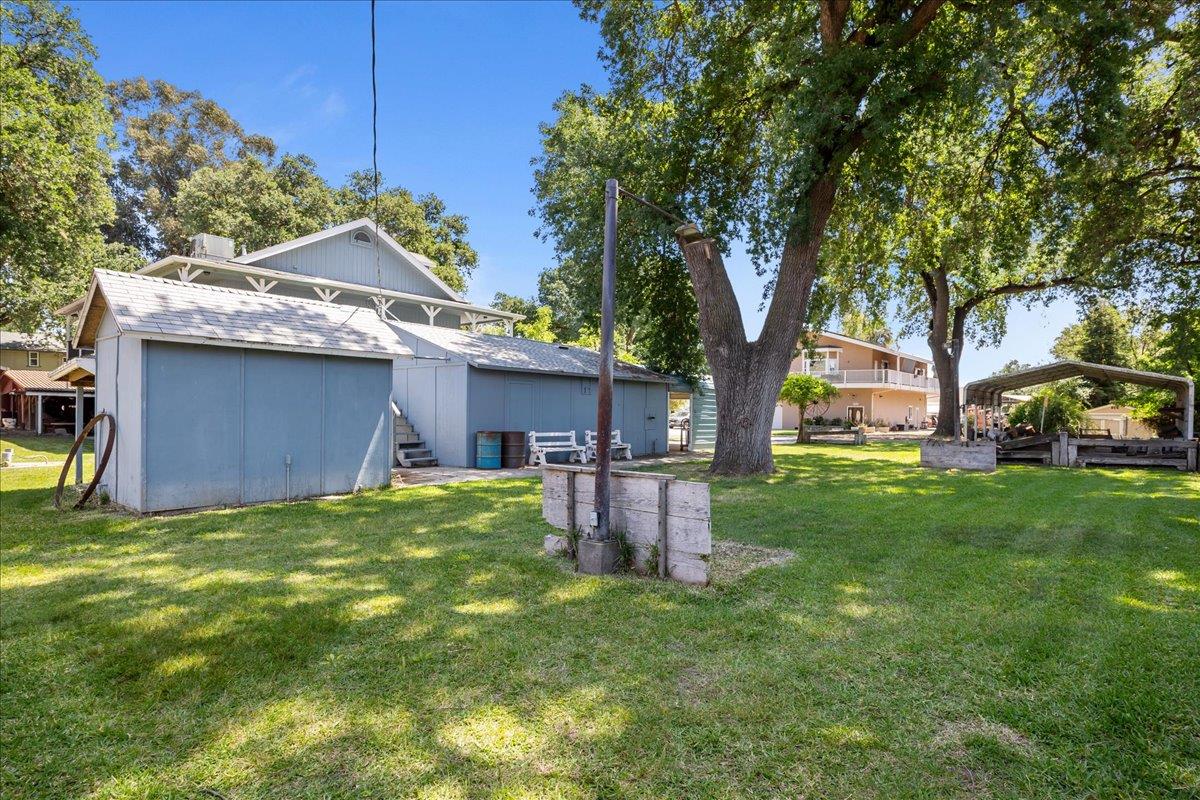 893 Wetherbee Avenue Manteca, CA 95337 - Photo 27 of 39 a view of a backyard with table and chairs and a barbeque