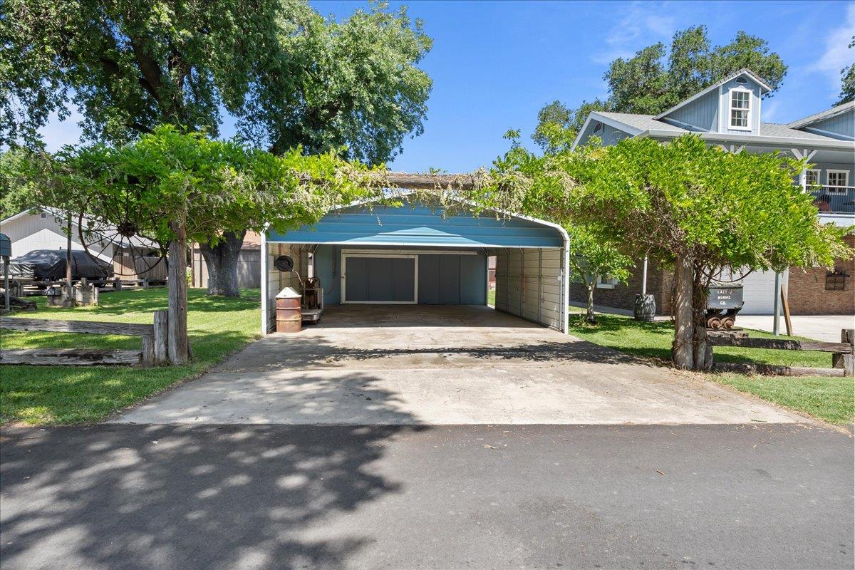 893 Wetherbee Avenue Manteca, CA 95337 - Photo 32 of 39 a front view of a house with a yard and garage