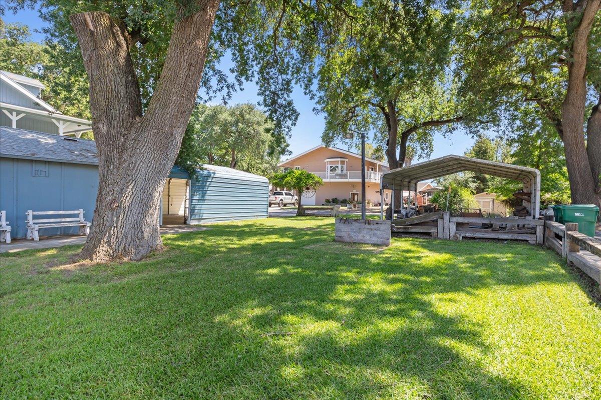 893 Wetherbee Avenue Manteca, CA 95337 - Photo 34 of 39 a view of house with garden and trees