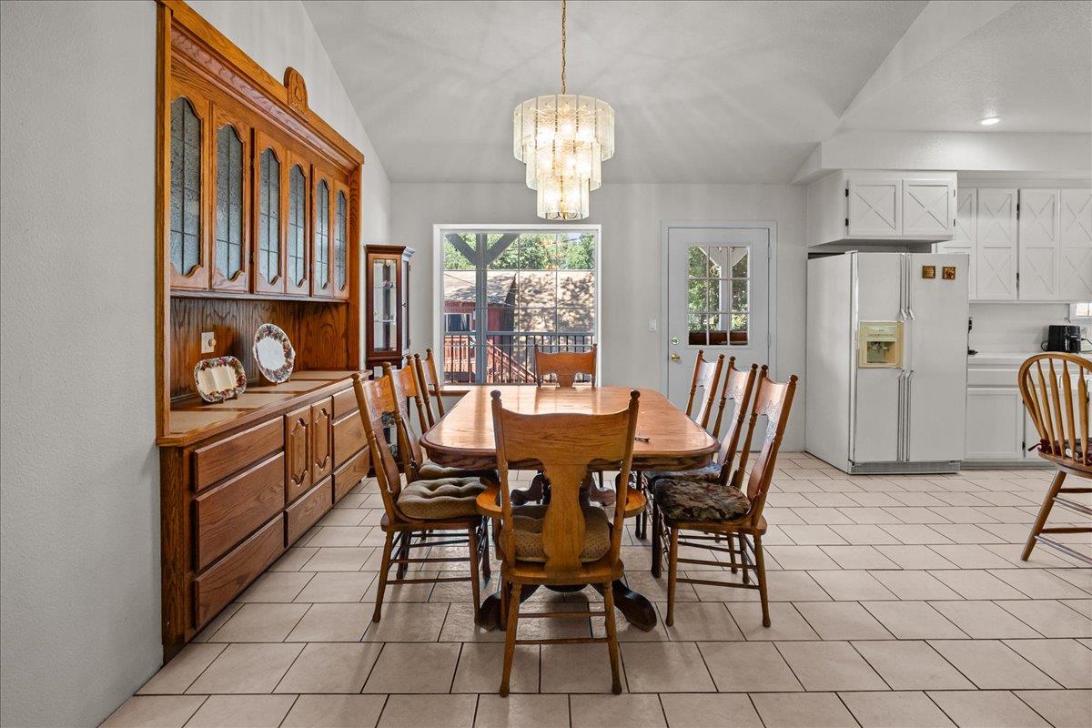 893 Wetherbee Avenue Manteca, CA 95337 - Photo 4 of 39 a dining room with furniture a chandelier and window
