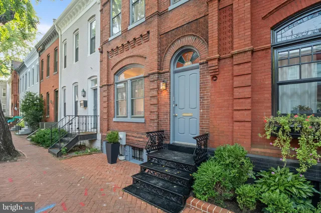 a view of a brick building with potted plants