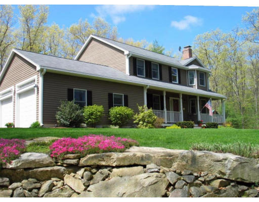 600 Boston Road Groton, MA 01450 - Photo 1 of 13 a front view of a house with a yard and a garage