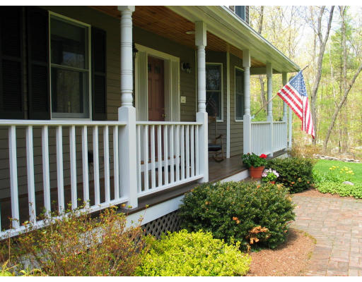 600 Boston Road Groton, MA 01450 - Photo 3 of 13 a view of a house with a small yard and flower plants