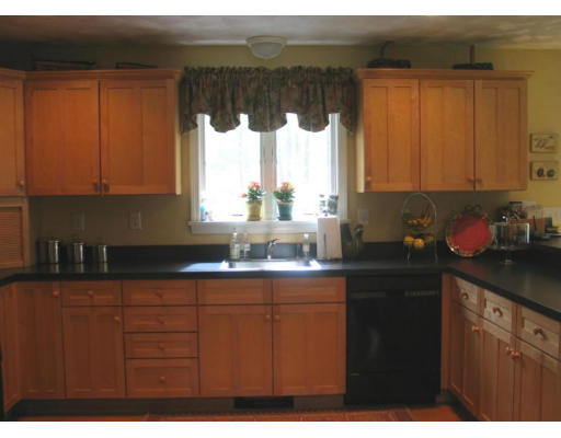 600 Boston Road Groton, MA 01450 - Photo 6 of 13 a kitchen with kitchen island granite countertop a sink window and cabinets
