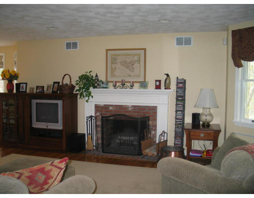 600 Boston Road Groton, MA 01450 - Photo 8 of 13 a living room with furniture a flat screen tv and a fireplace