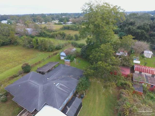 an aerial view of a house with a yard