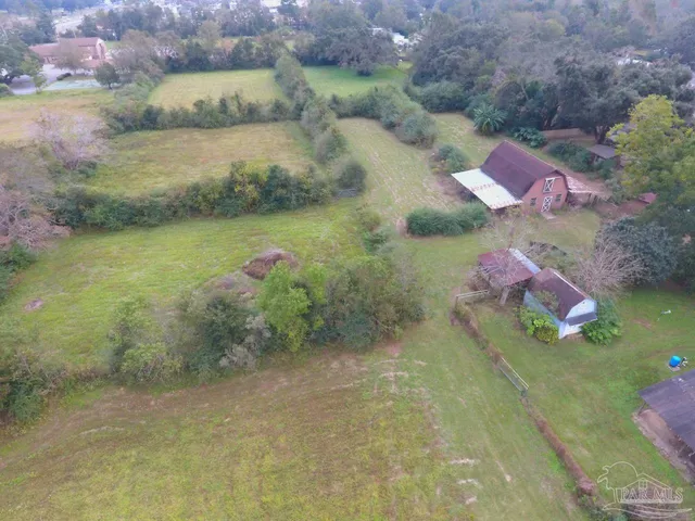 a aerial view of a house with a yard