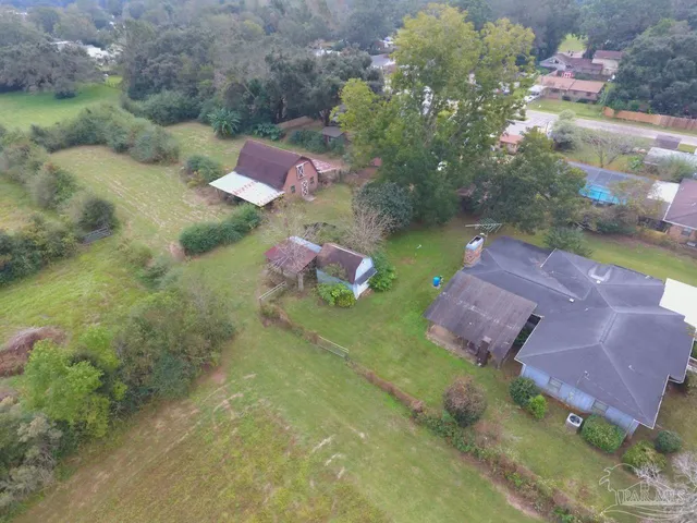 an aerial view of a house with a yard