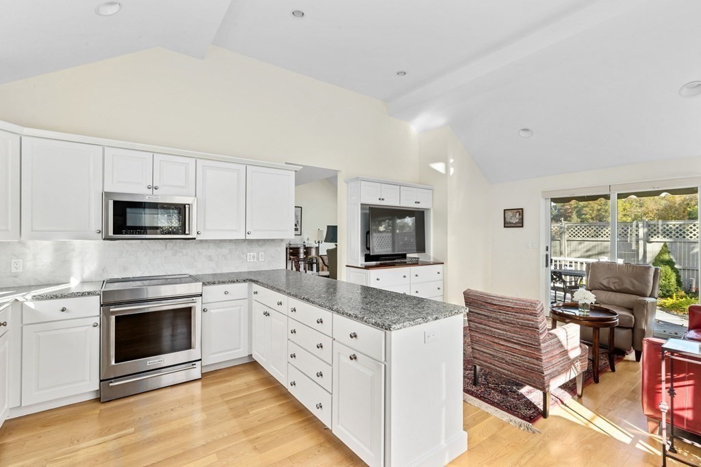 50 Floret Circle, Unit 50 Hingham, MA 02043 - Photo 1 of 28 a kitchen with granite countertop a stove top oven microwave and cabinets