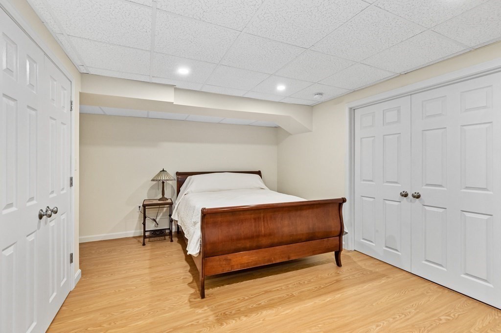 50 Floret Circle, Unit 50 Hingham, MA 02043 - Photo 17 of 28 a bedroom with a bed and a table