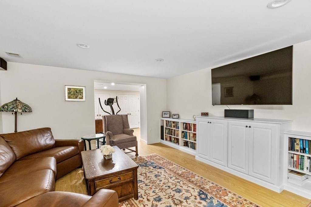 50 Floret Circle, Unit 50 Hingham, MA 02043 - Photo 18 of 28 a living room with furniture and a flat screen tv