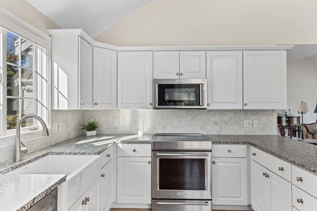 50 Floret Circle, Unit 50 Hingham, MA 02043 - Photo 2 of 28 a kitchen with white cabinets stainless steel appliances and sink