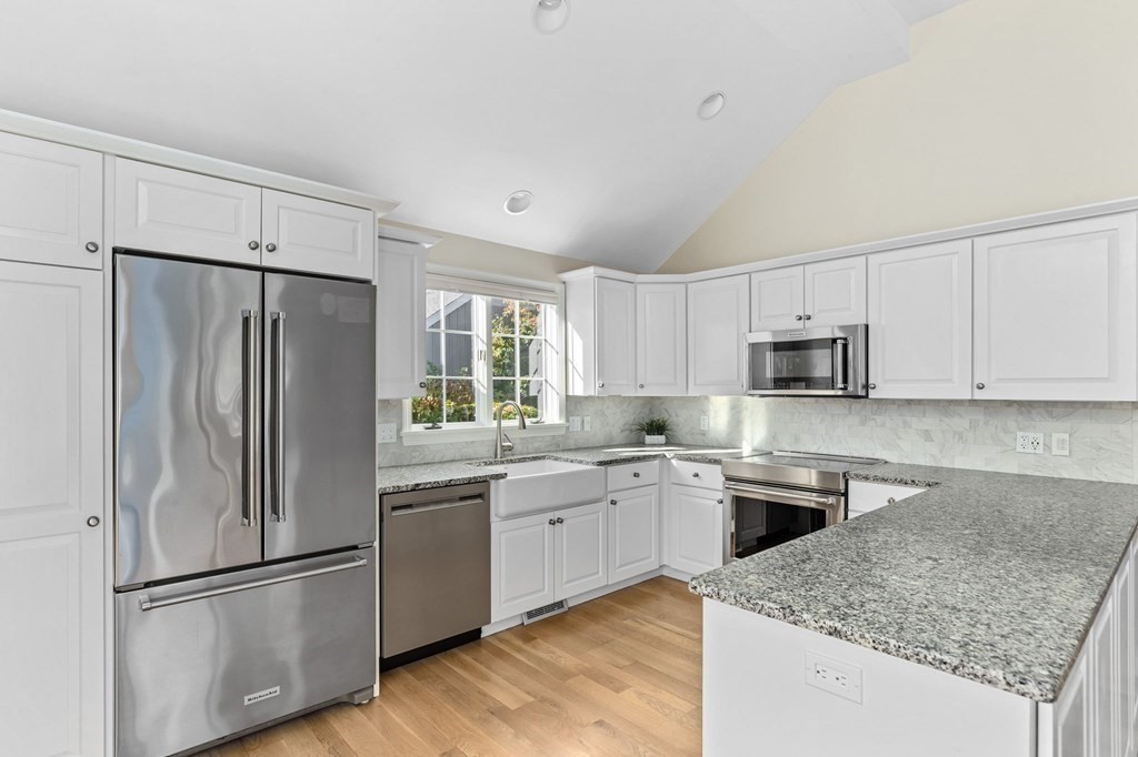 50 Floret Circle, Unit 50 Hingham, MA 02043 - Photo 3 of 28 a kitchen with stainless steel appliances granite countertop a refrigerator sink and microwave