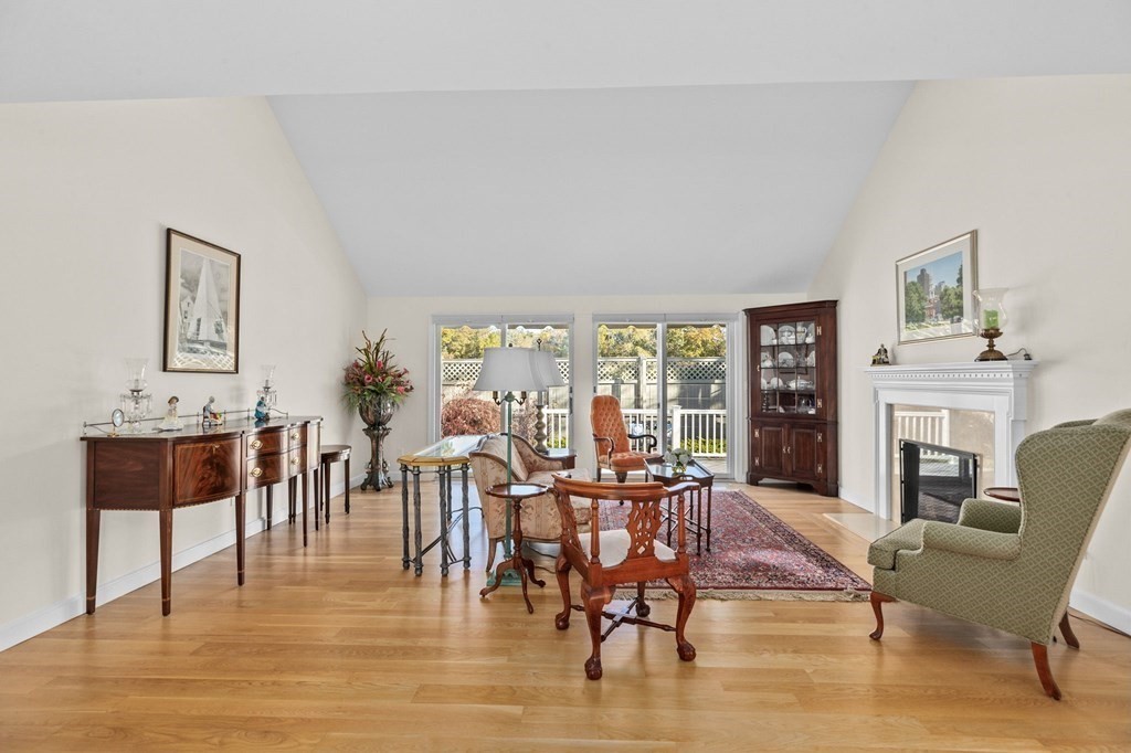 50 Floret Circle, Unit 50 Hingham, MA 02043 - Photo 8 of 28 a living room with furniture a fireplace and a large window