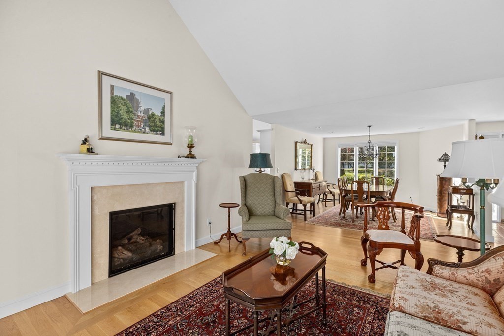 50 Floret Circle, Unit 50 Hingham, MA 02043 - Photo 10 of 28 a living room with furniture a rug and a fireplace