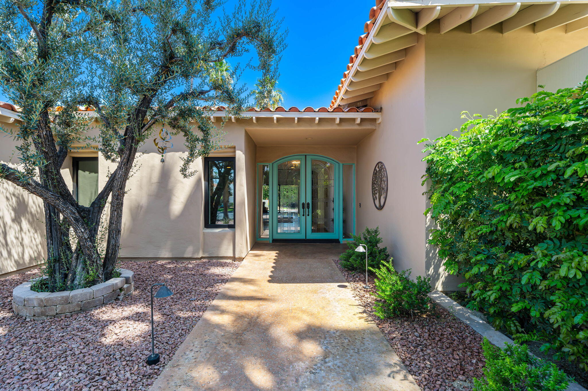5 Terrace Place Rancho Mirage, CA 92270 - Photo 14 of 53 a front view of a house with garden