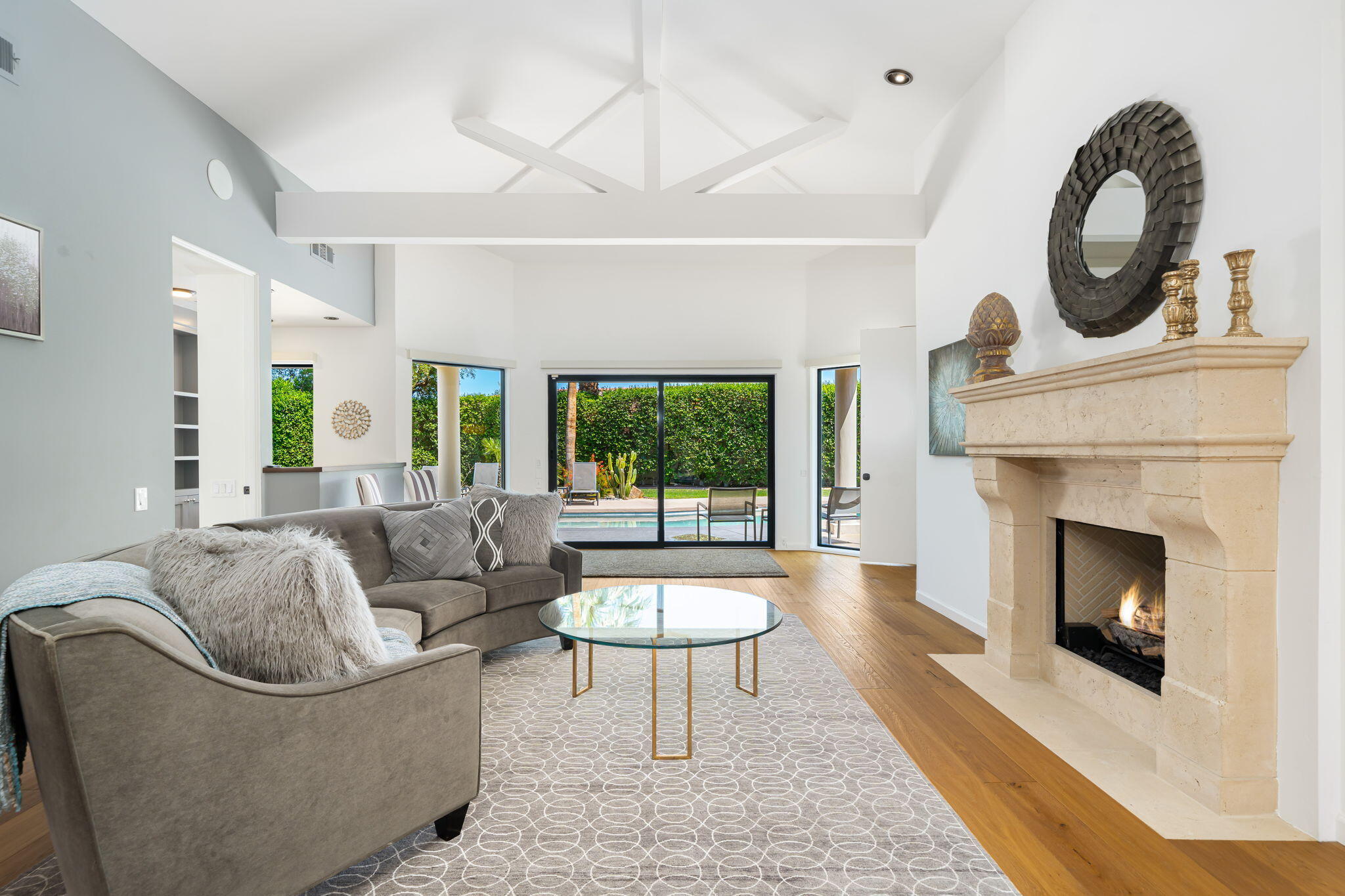 5 Terrace Place Rancho Mirage, CA 92270 - Photo 17 of 53 a living room with furniture a fireplace and a large window