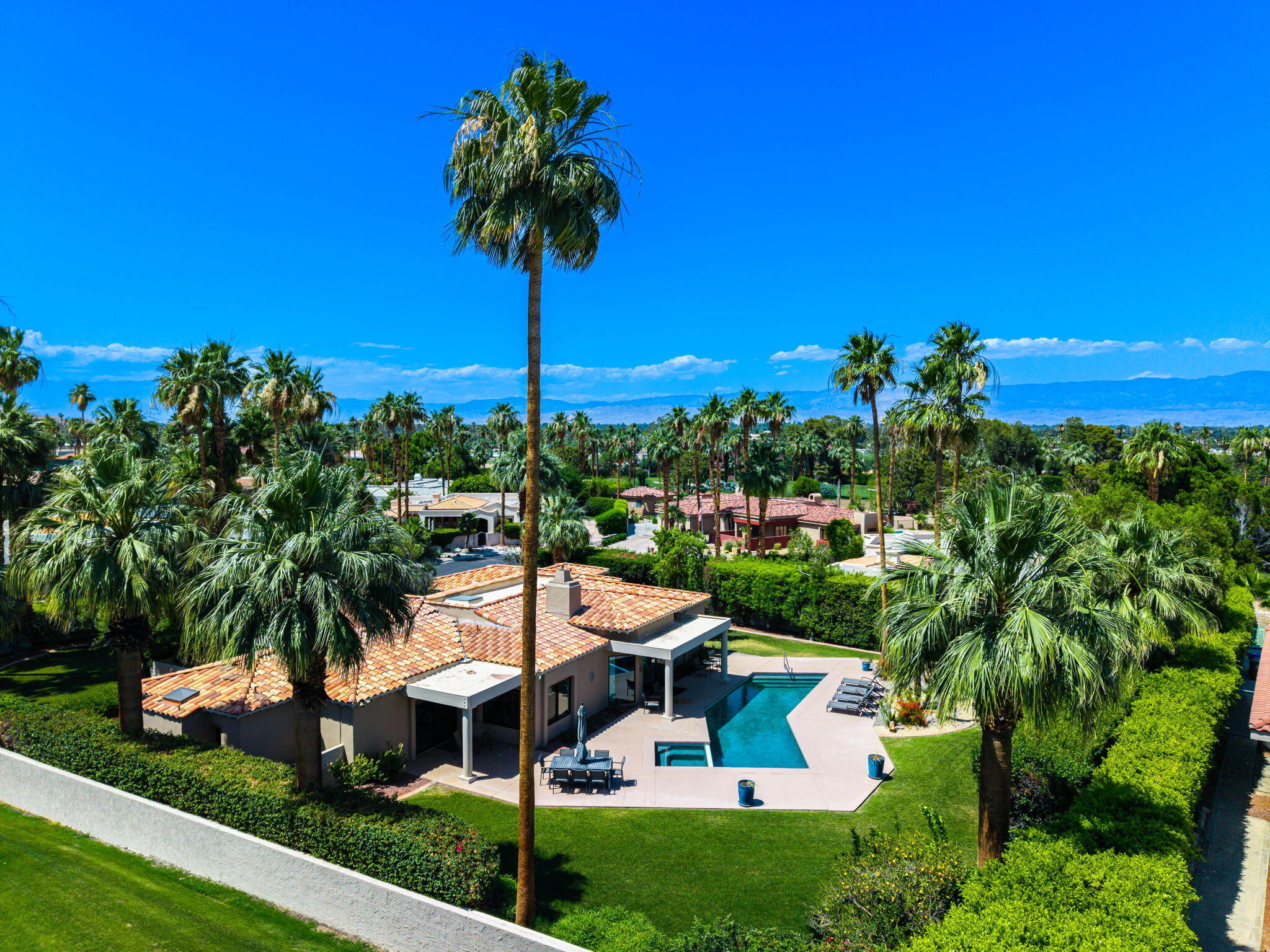 5 Terrace Place Rancho Mirage, CA 92270 - Photo 2 of 53 a view of a house with a yard and potted plants