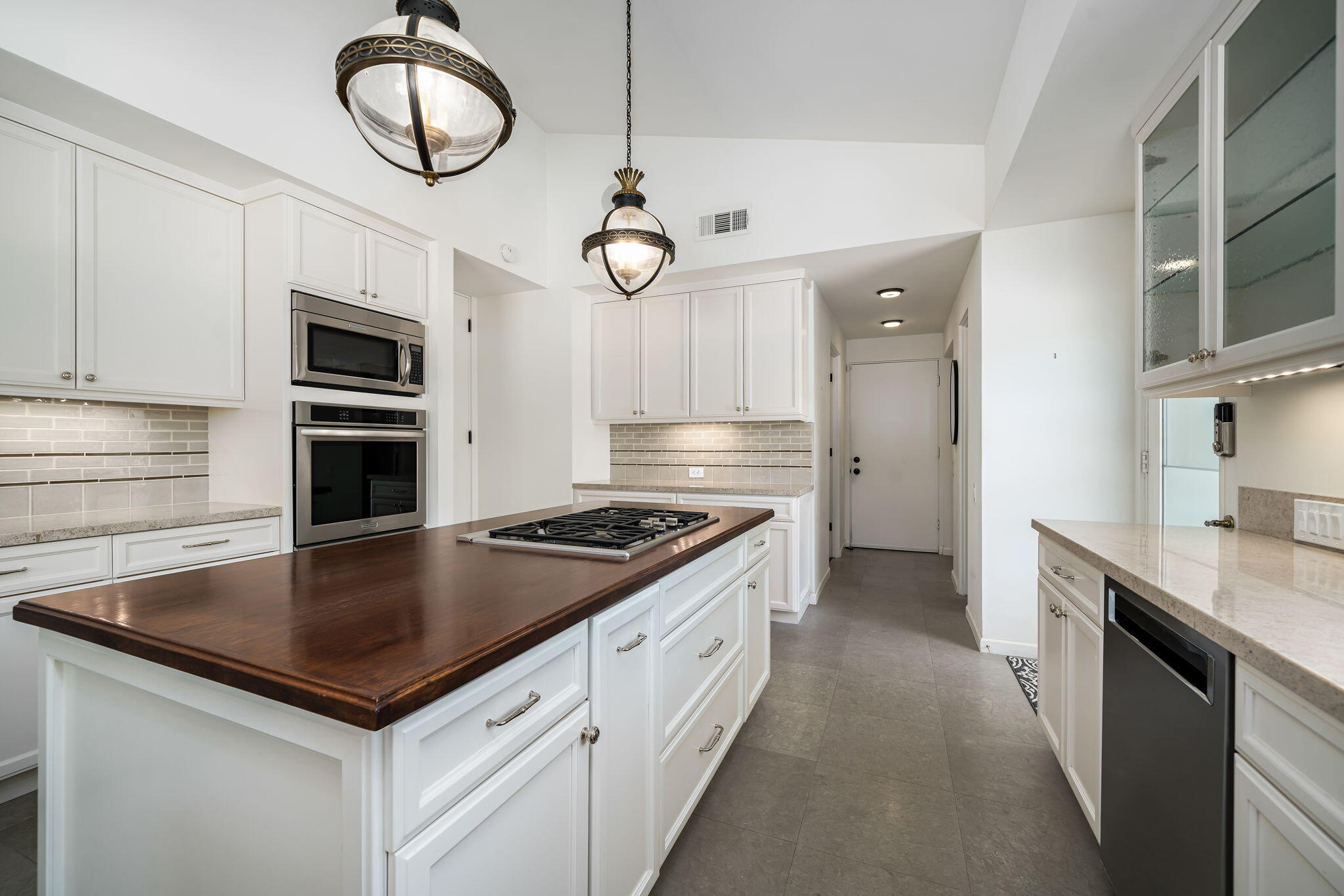 5 Terrace Place Rancho Mirage, CA 92270 - Photo 26 of 53 a kitchen with a stove microwave and a refrigerator
