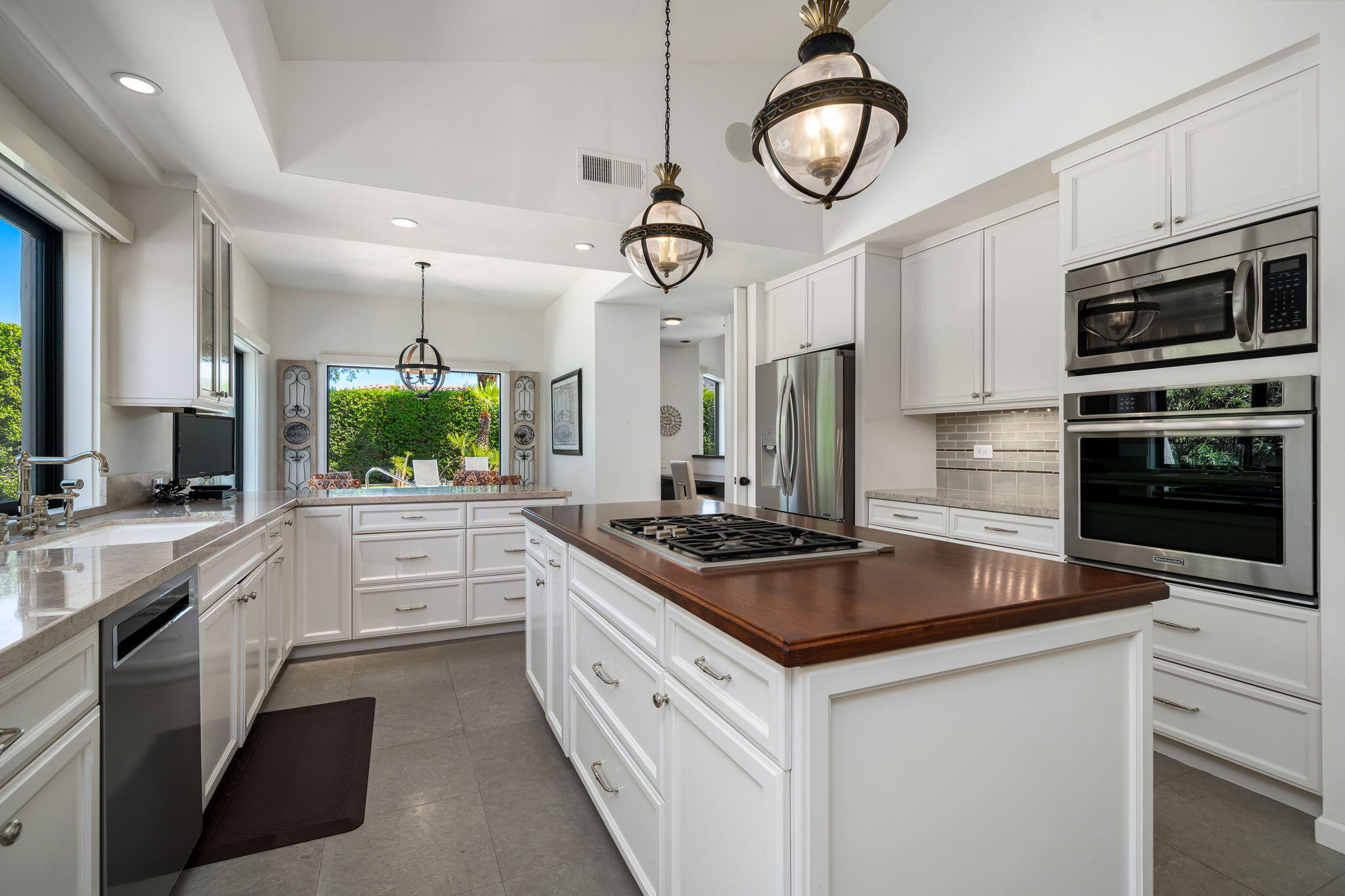 5 Terrace Place Rancho Mirage, CA 92270 - Photo 27 of 53 a kitchen with stainless steel appliances a stove a sink and a refrigerator