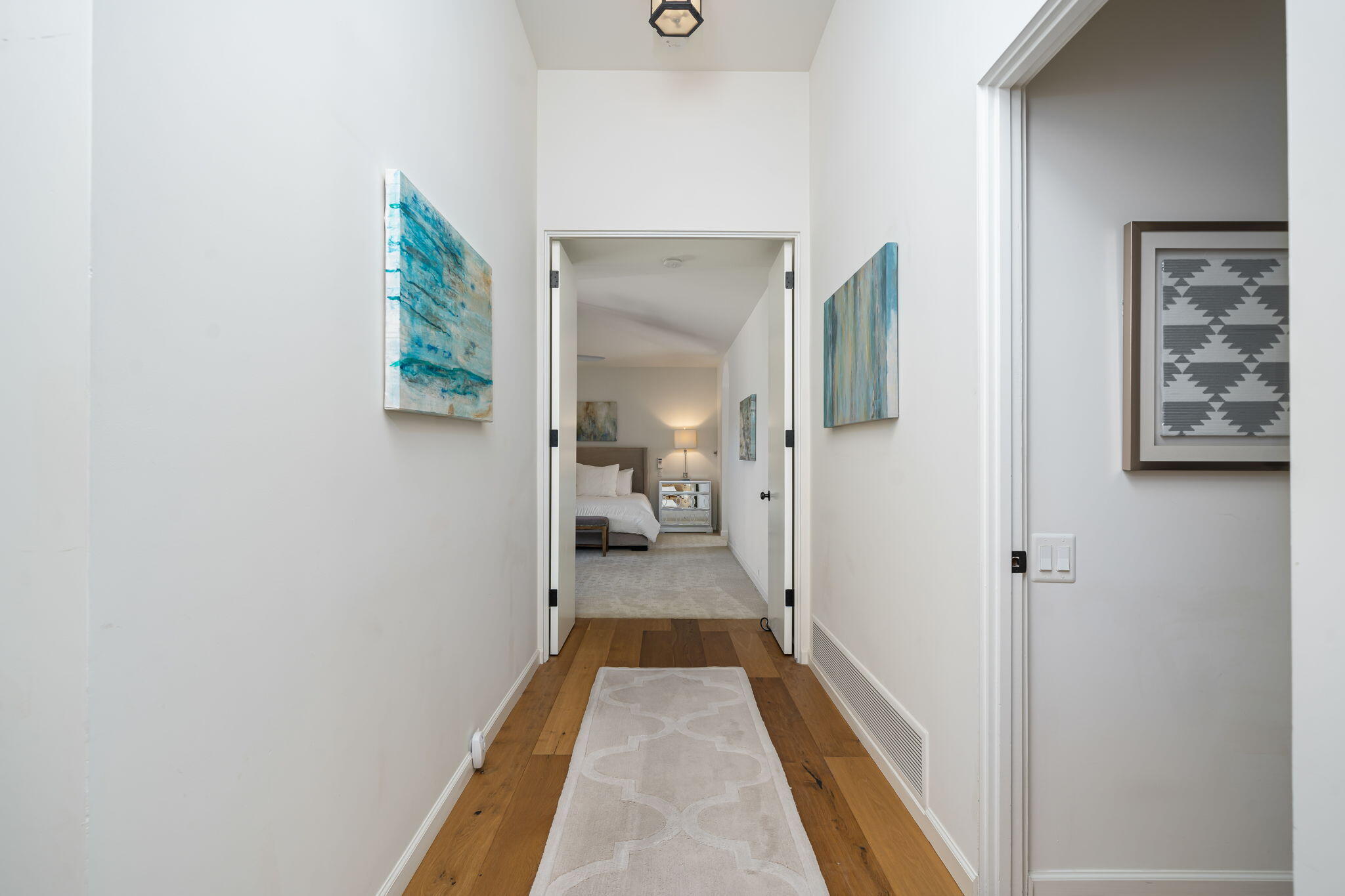 5 Terrace Place Rancho Mirage, CA 92270 - Photo 30 of 53 a view of a hallway with wooden floor and a bathroom