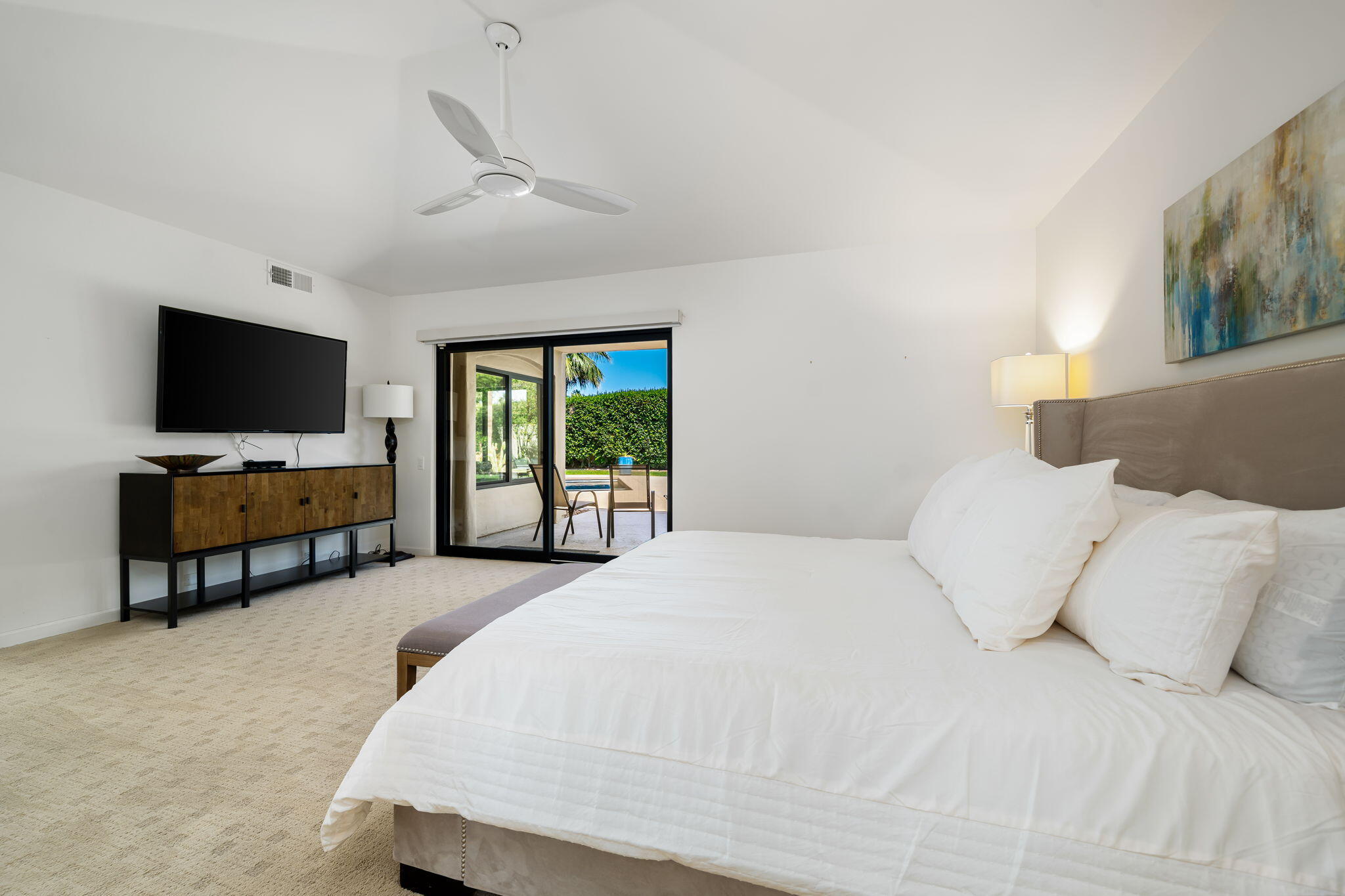 5 Terrace Place Rancho Mirage, CA 92270 - Photo 32 of 53 a spacious bedroom with a bed and a flat screen tv