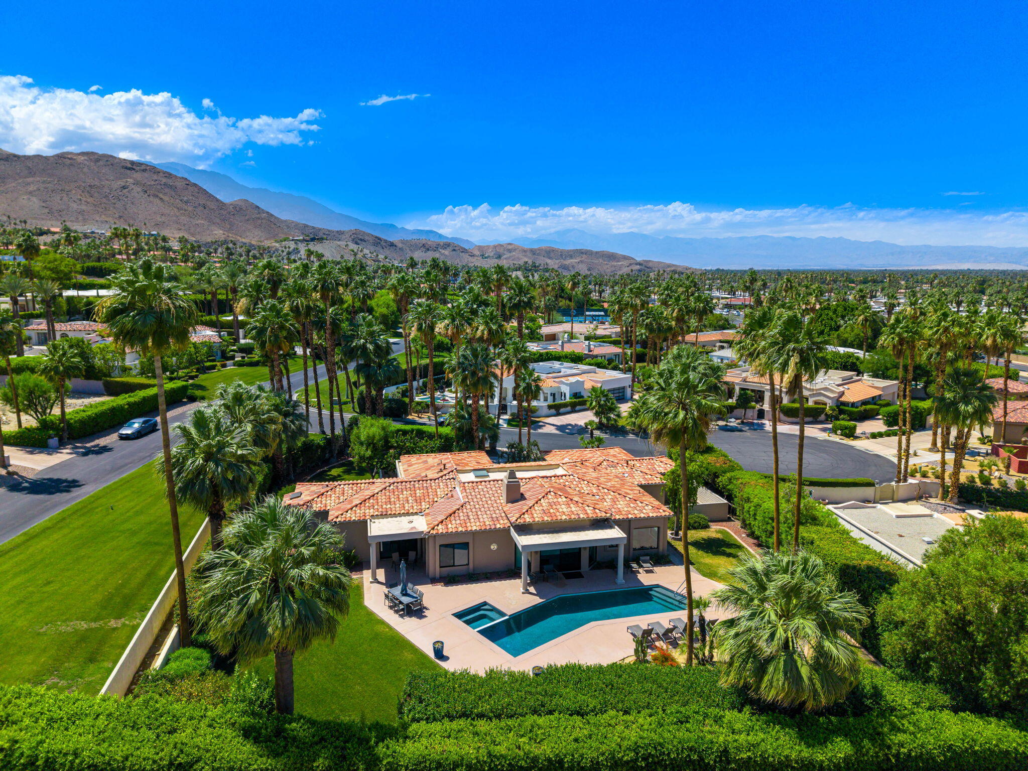 5 Terrace Place Rancho Mirage, CA 92270 - Photo 4 of 53 a view of a patio with couches table and chairs under an umbrella