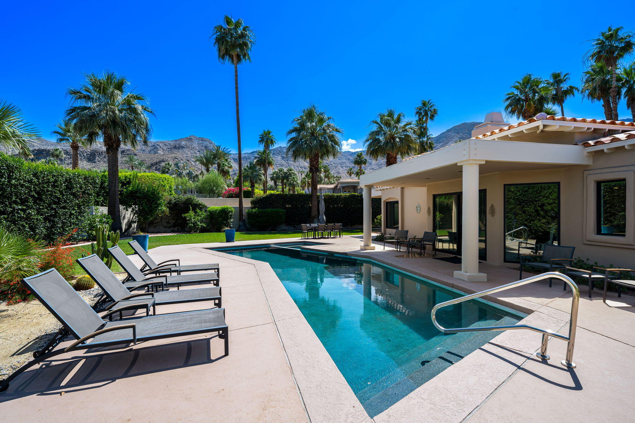 5 Terrace Place Rancho Mirage, CA 92270 - Photo 48 of 53 a view of a swimming pool with chairs