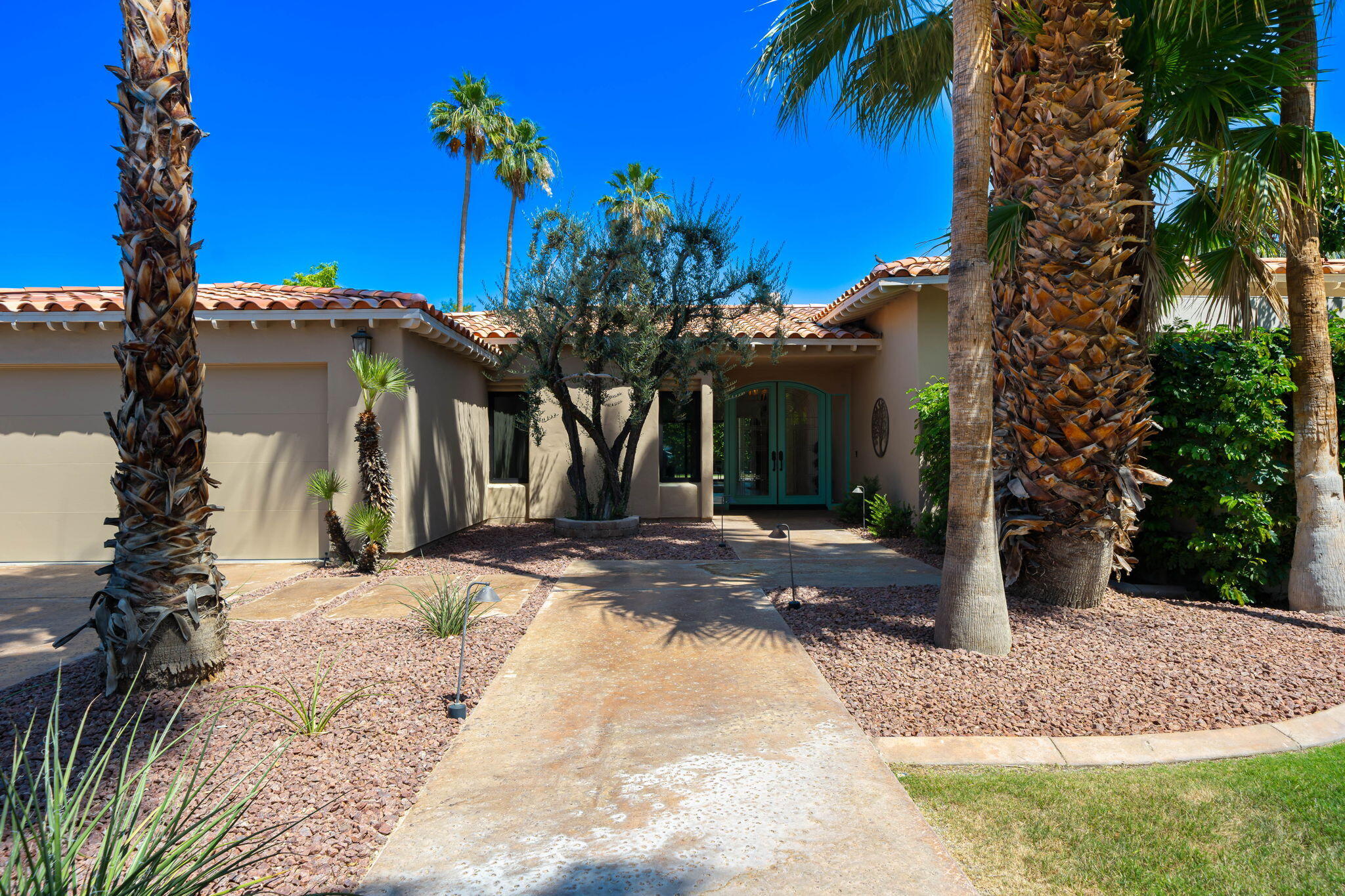 5 Terrace Place Rancho Mirage, CA 92270 - Photo 10 of 53 a view of a house with a tree in front of it