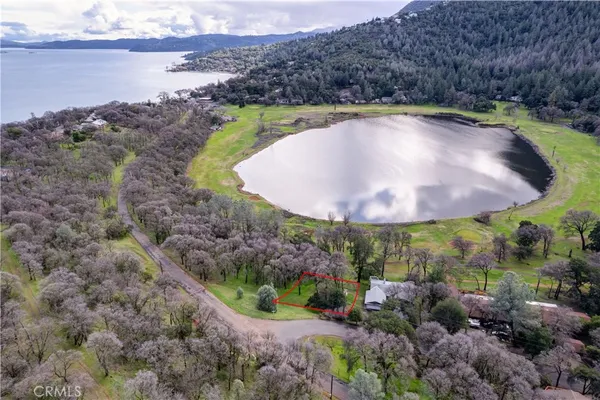 a view of a swimming pool with a yard and lake view