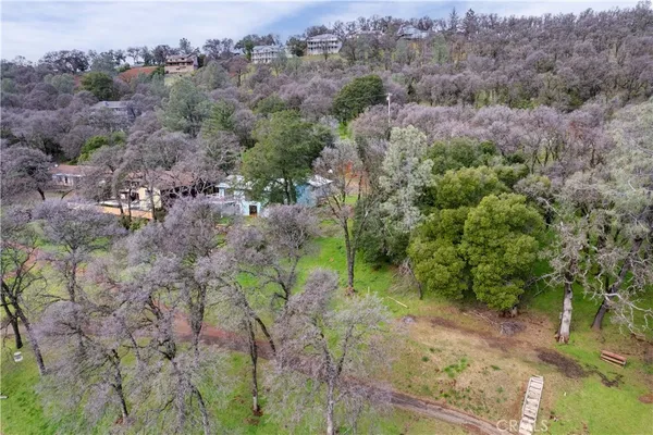 an aerial view of residential house with green space