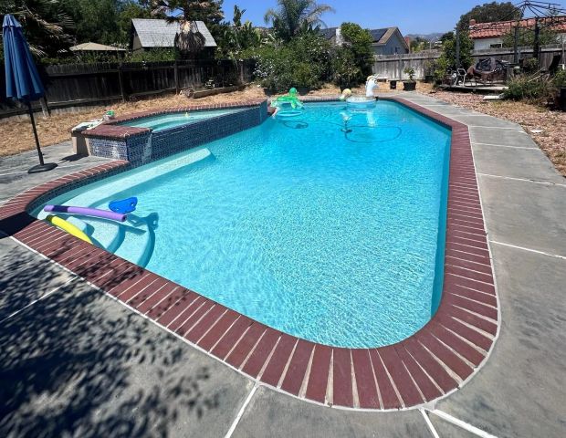 a view of a swimming pool with a lounge chairs