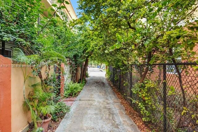 542 Northwest 8th Street, Unit 12 Miami, FL 33136 - Photo 14 of 14 a view of a pathway with plants and a large tree