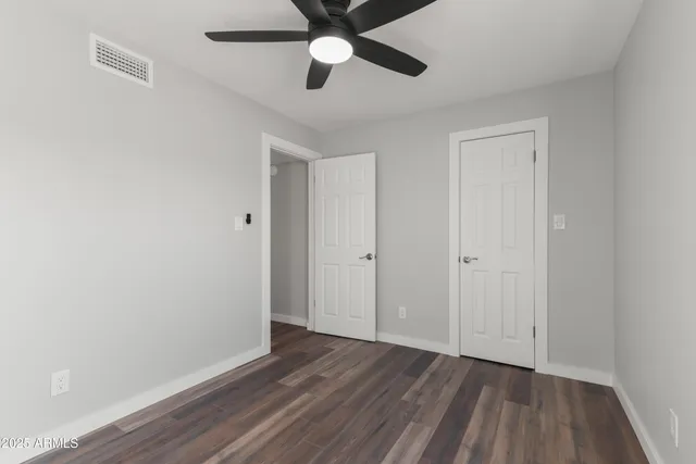 a view of an empty room and wooden floor