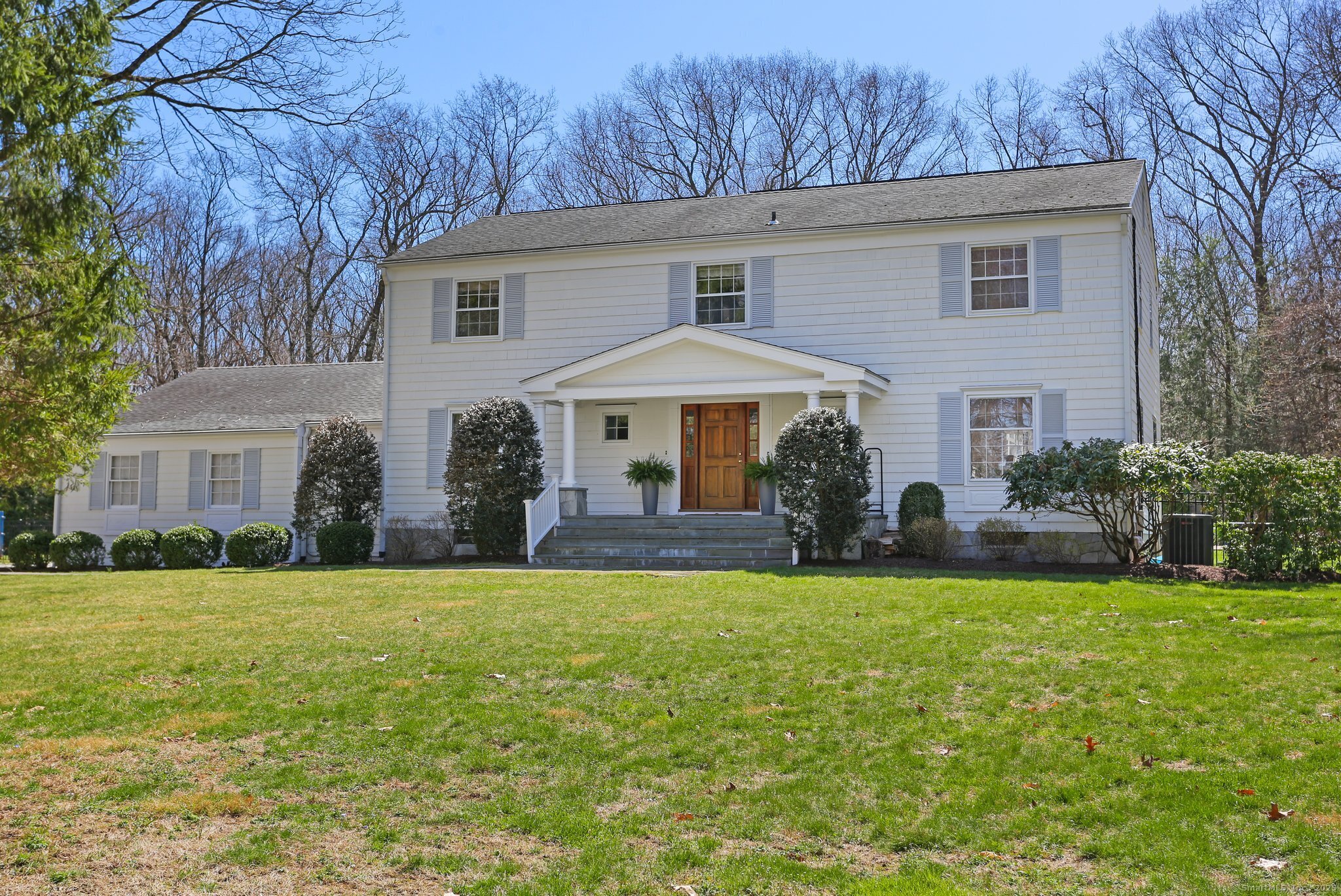 7 Apache Trail Westport, CT 06880 - Photo 1 of 35 a front view of a house with a yard and trees