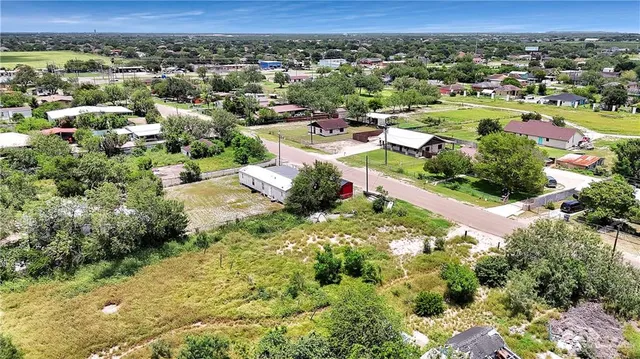 an aerial view of a houses with a yard