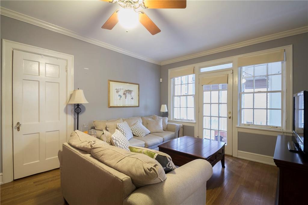 8 Collier Road Northwest, Unit A4 Atlanta, GA 30309 - Photo 1 of 1 Main Living Room with large windows looking out to screened in Porch. Refinished hardwood flooring and ceiling fan.