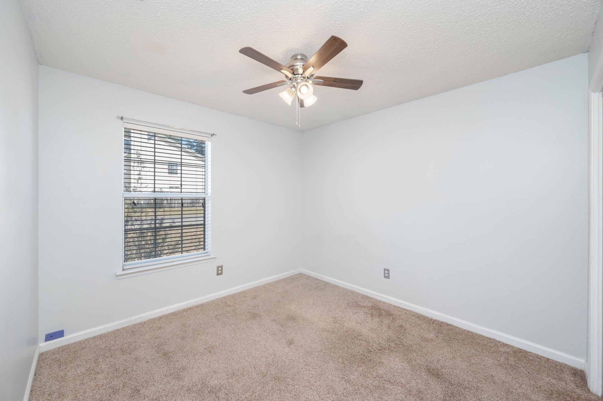 9 Holly Road Crestview, FL 32539 - Photo 19 of 32 an empty room with a window and a ceiling fan