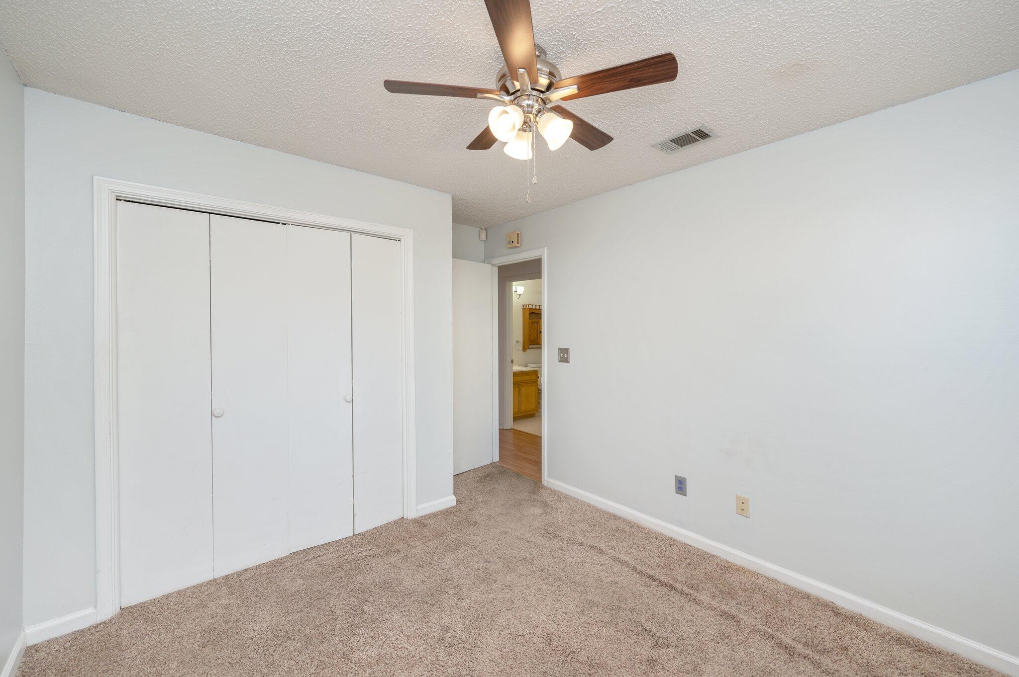 9 Holly Road Crestview, FL 32539 - Photo 20 of 32 an empty room with closet and a ceiling fan
