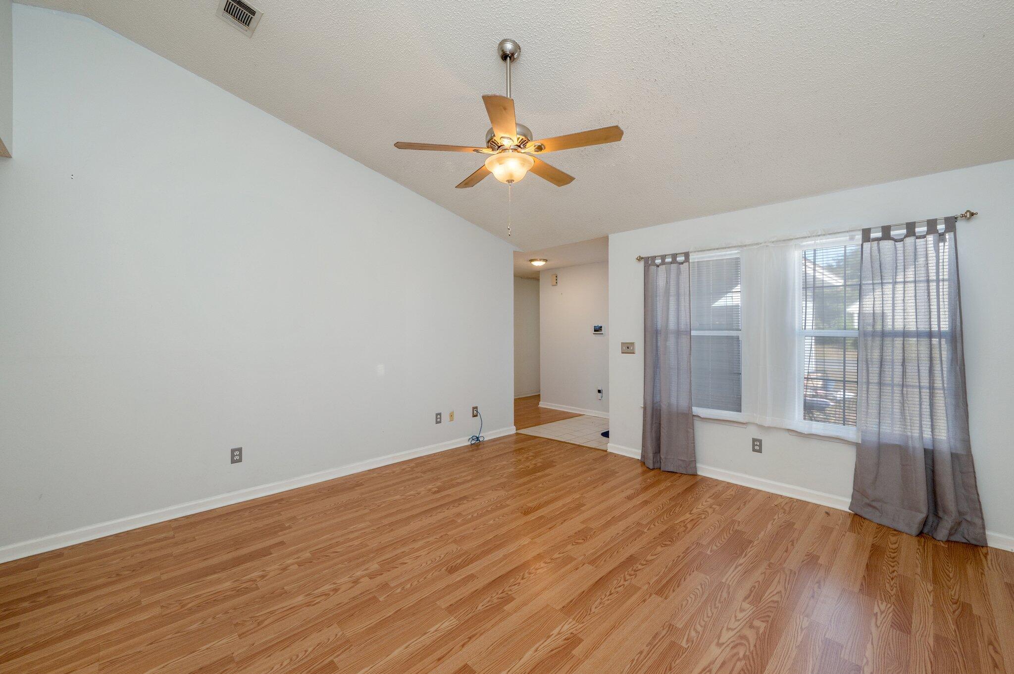 9 Holly Road Crestview, FL 32539 - Photo 4 of 32 a view of empty room with wooden floor and fan