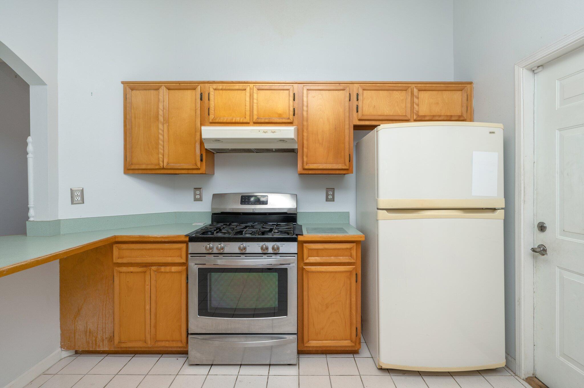 9 Holly Road Crestview, FL 32539 - Photo 9 of 32 a kitchen with a stove a fridge and a refrigerator