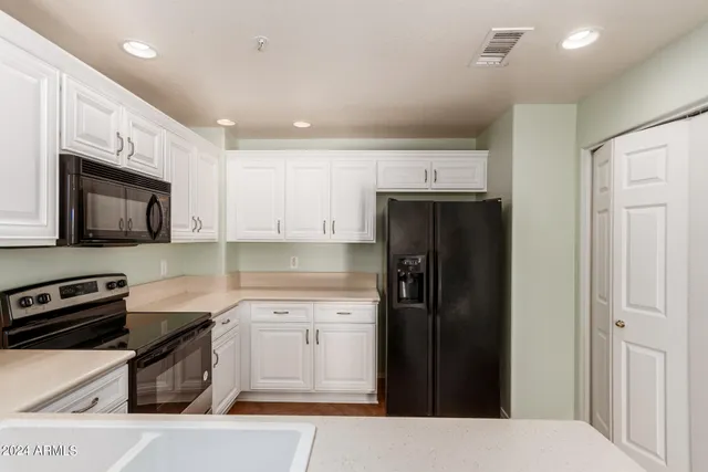 a kitchen with a refrigerator stove and sink