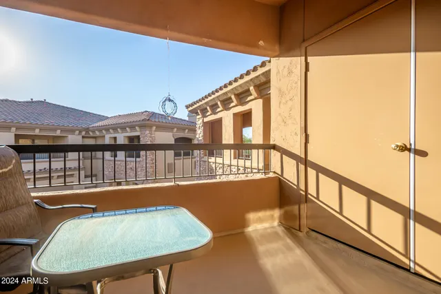 a view of balcony with a table and chairs
