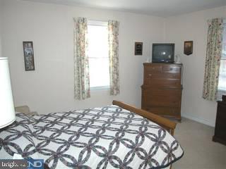 432 Barker Road Springfield, PA 19064 - Photo 4 of 6 a bedroom with a bed and a window