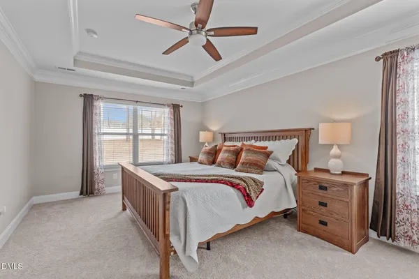 a bedroom with a bed a bed and a chandelier